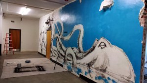 Laying out the background color with a roller brush.